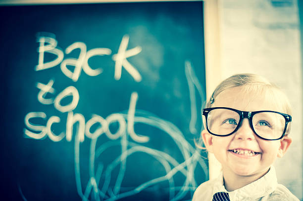 istock Smart little girl stood infront of a blackboard 524625443