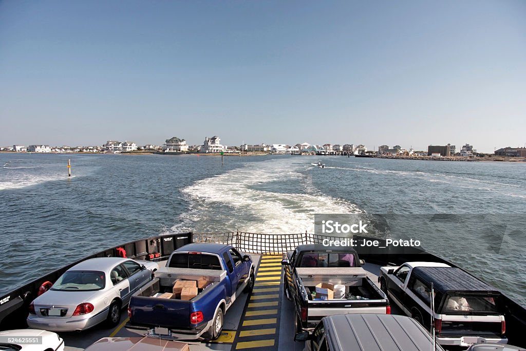 Ferry Transportation Cars and trucks departing on ferry from Cape Hatteras Village to Ocracoke Island. Horizontal. Ferry Stock Photo