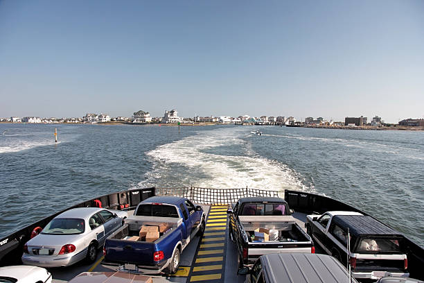 Ferry Transportation Cars and trucks departing on ferry from Cape Hatteras Village to Ocracoke Island. Horizontal. ocracoke island stock pictures, royalty-free photos & images