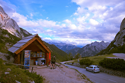 Vršič, Slovenia - August 17, 2014: A bicyclist made a brief stop at Vršič mountain pass to get some food and drinks. It was a hard way to the top anyway.