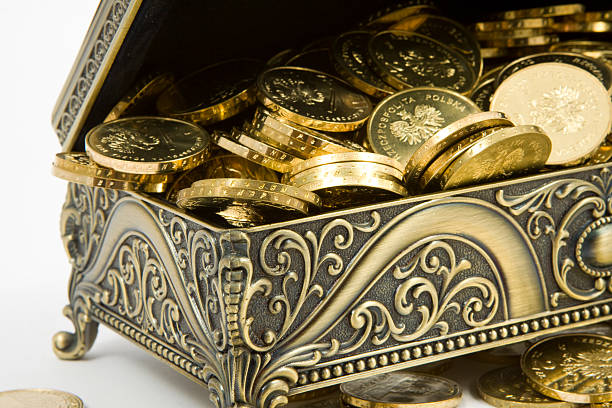 istock gold casket and gold coins on a white background 524649785