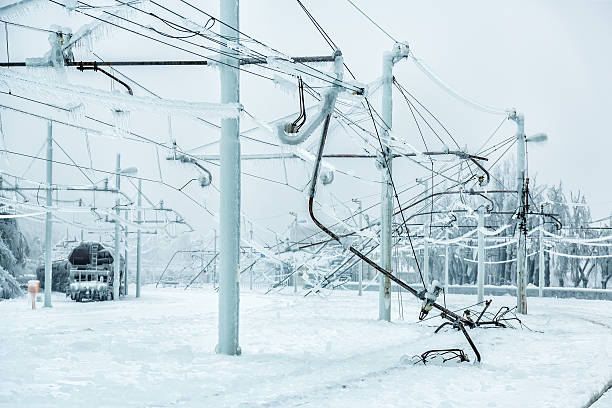 Ice frozen damaged railway electric power system in winter.