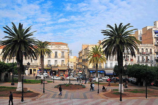 Oran, Algeria:colonial heart of the city Oran, Algeria - January 27, 2008: people on Cathedral square / Place de la Kahina and traffic along Boulevard Hammou Bou Tlelis oran algeria photos stock pictures, royalty-free photos & images