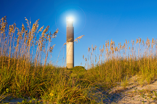 Oak Island Southport North Carolina Lighthouse through the Casswell Beach seagrass at sunset