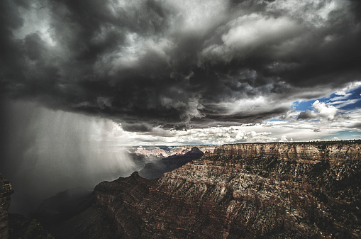 Look out over Grand Canyon rock formations in winter as snow cloud desecends