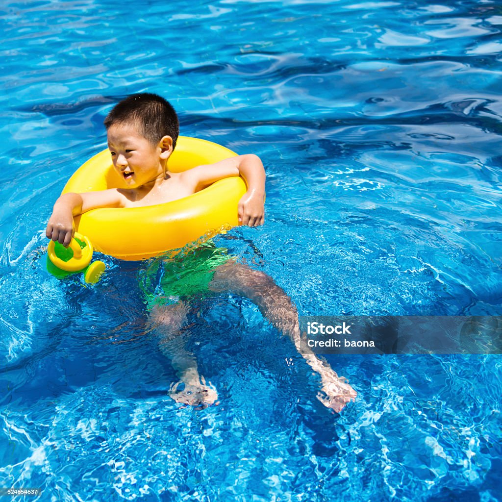 boy swimming at pool Little boy swimming at pool. 4-5 Years Stock Photo