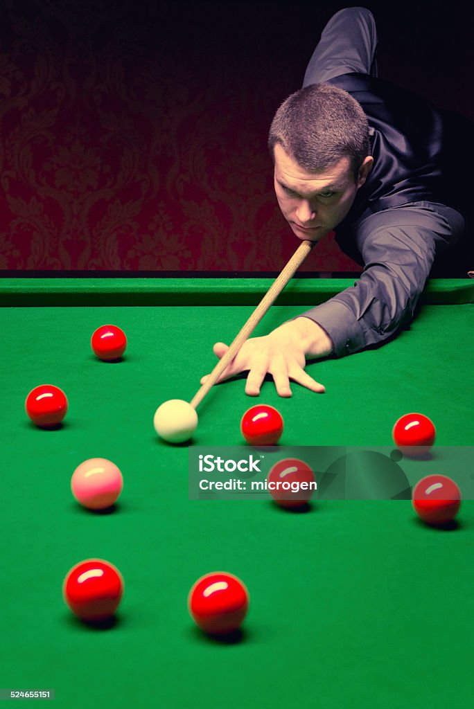 Snooker Pro Professional snooker player having a shot. Toned image Snooker Stock Photo
