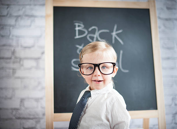 istock Smart little girl stood infront of a blackboard 524655617