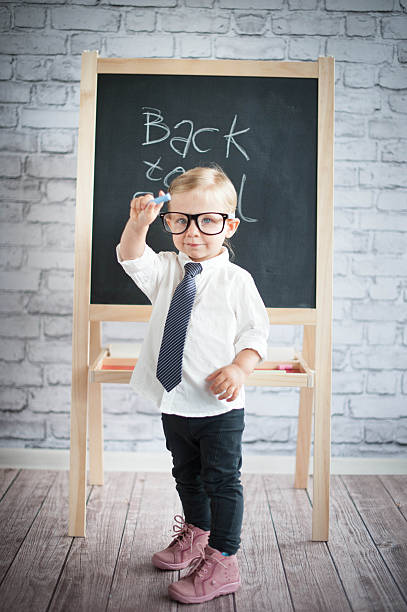 istock Smart little girl stood infront of a blackboard 524655877