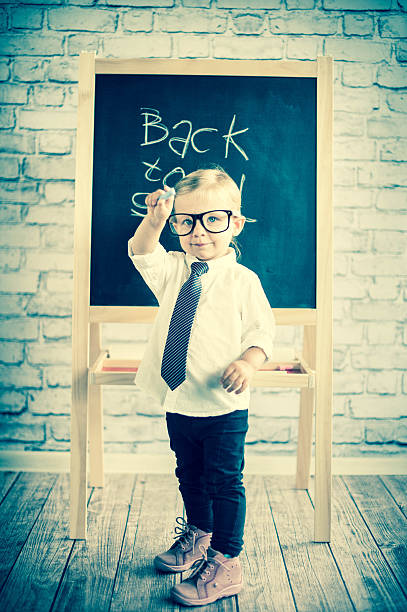 istock Smart little girl stood infront of a blackboard 524655891
