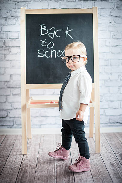 istock Smart little girl stood infront of a blackboard 524655929