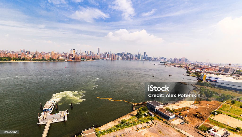 View to the Hudson River between Manhattan and Brooklyn View to the Hudson River between Manhattan and Brooklyn from balcony in Williamsburg. Ferry arrive to the North Williamsburg Pier for boarding  Aerial View Stock Photo