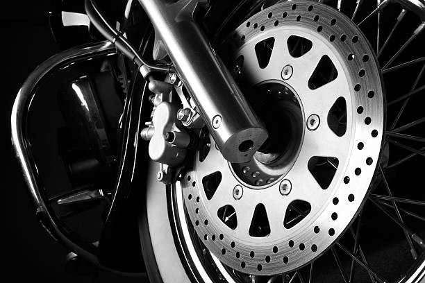 Motorcycle brake disc Brake disc on the front wheel of a cruiser motorcycle. Black and white studio image. brake disc photos stock pictures, royalty-free photos & images