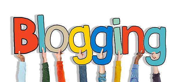 istock Diverse Hands Holding the Word Blogging 524687071