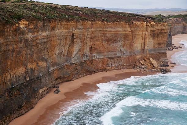 istock Sandstone cliffs on coastline near Twelve Apostles, Australia 524688213