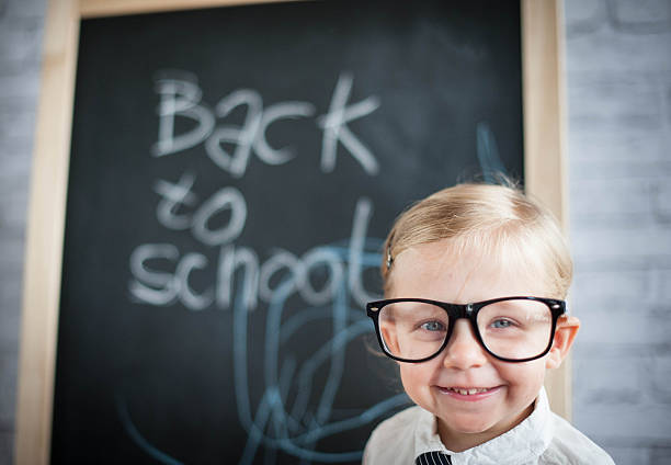 istock Smart little girl stood infront of a blackboard 524688649