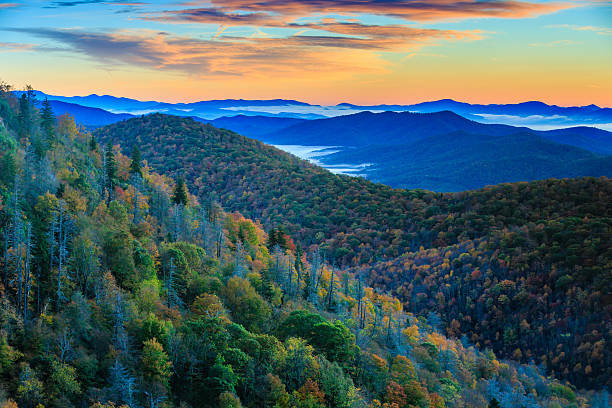 Blue Ridge Mountains at Sunrise Autumn sunrise over the East Fork of the Pigeon River in the Blue Ridge mountains of Western North Carolina. blue ridge parkway stock pictures, royalty-free photos & images