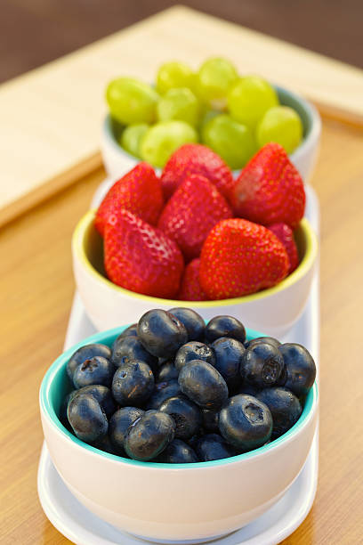 istock Blueberries, strawberries and grapes in cans 524692545
