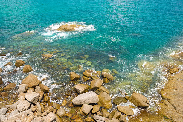 istock Tropical beach with stones and waves at Thailand 524693233