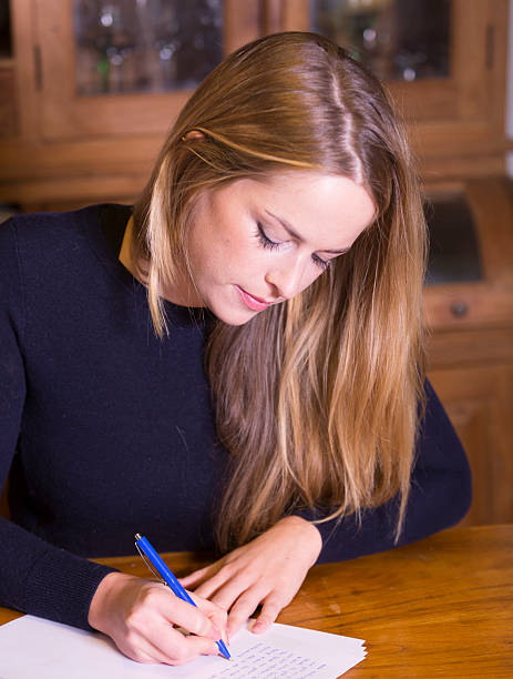 istock Woman writing on paper 524697416