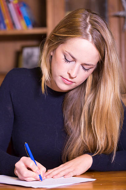 istock Woman writing on paper 524697492