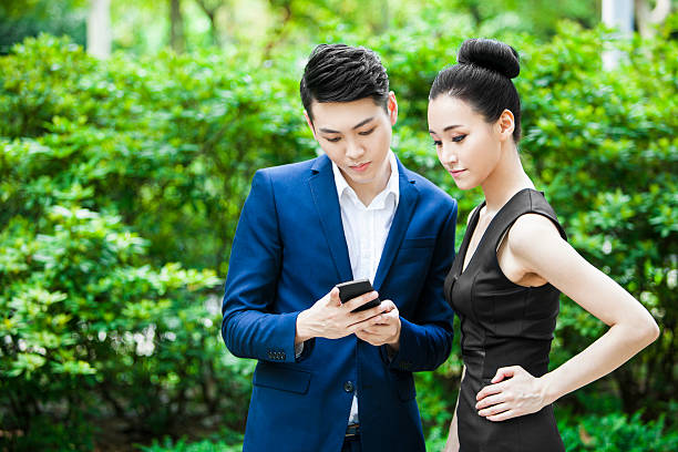 istock Young Asian Colleagues Checking Social Media Response Using Smartphone 524697614