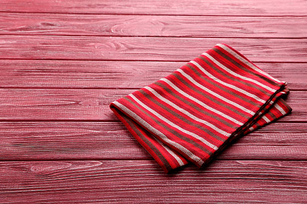 istock Napkin on red wooden table, close up 524697738