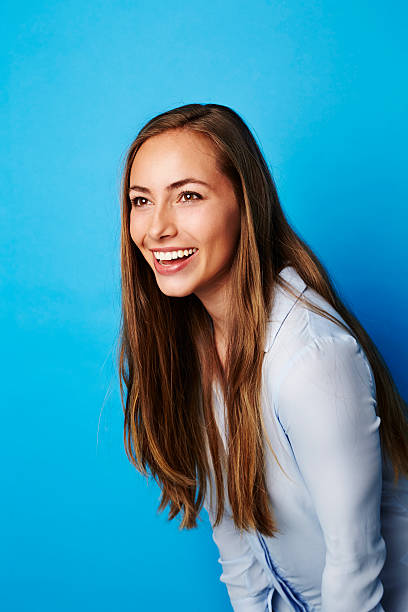 istock Smiling beautiful woman in blue studio 524700818