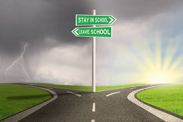 istock Road with two choices to stay or leave school 524702556
