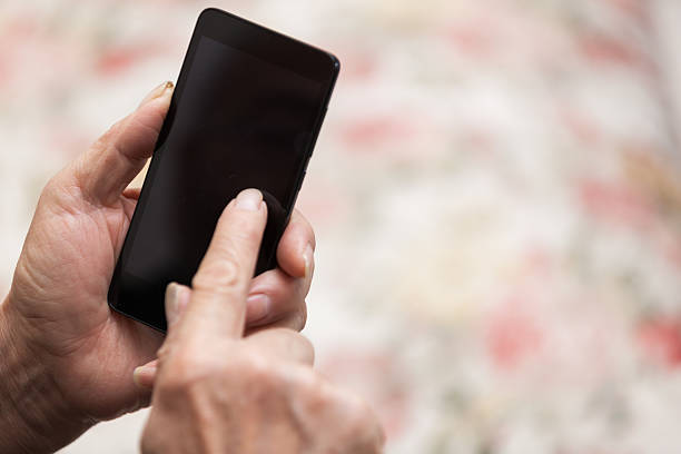 istock Asian old man use smart phone indoors 524702972