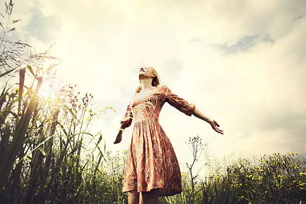 Photo of woman taking a breath in the middle of the nature