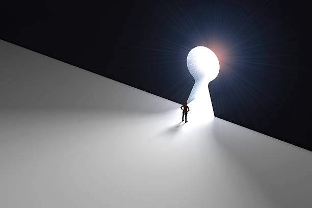 istock Figure in front of a bright keyhole opening 524704282