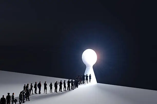 Photo of People in front of a bright keyhole opening