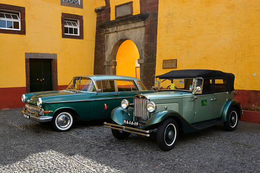 Funchal, Portugal - January 27, 2016: Old classic and vintage automobiles in the courtyard of the Fort of Saint Tiago in Funchal, Madeira, Portugal