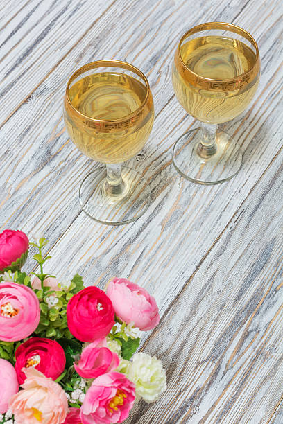 istock Two glasses of white wine and flowers 524706712