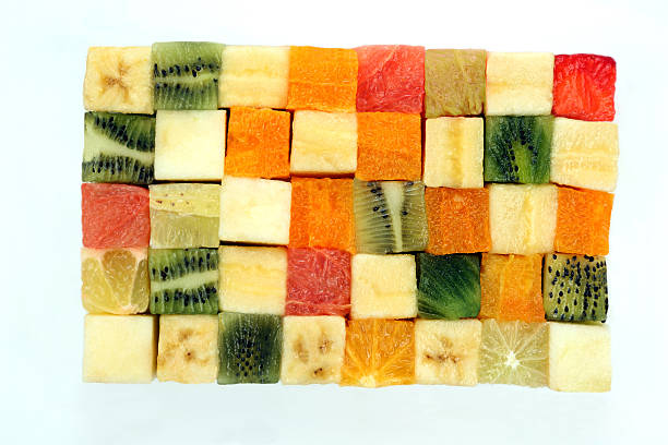 istock fresh fruits cut in cubes stacked together on white background 524707800