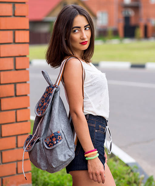 istock Young beautiful girl posing on brick wall background, with a 524708046
