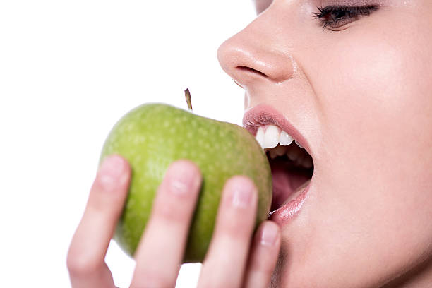 istock Woman eating an apple 524709386