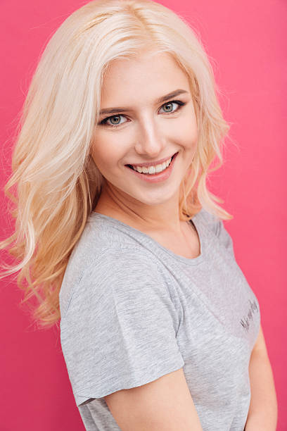 istock Woman looking at camera over pink background 524709500
