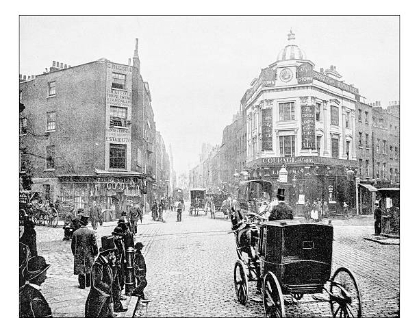 Antique photograph of Seven Dials junction in London (19th century) Antique photograph of Seven Dials junction in London as it was in the late 19th century. It is a small circular square, a road junction of seven streets in Covent Garden in the West End of London. In the picture the square, busy with people and carriages, with its buildings with pubs and shops of a district tha was quite poor (now it's a fashionable shopping district). city of westminster london photos stock illustrations