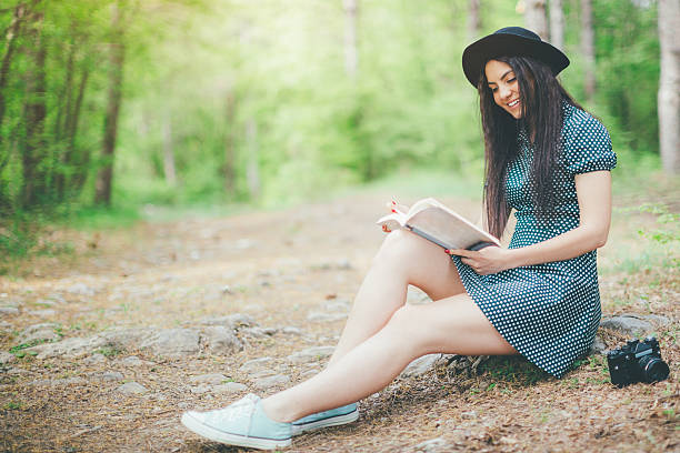 istock beautiful young girl reading a book 524709888