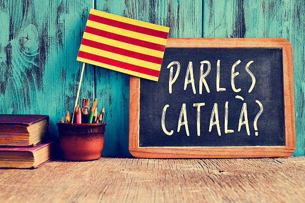 question parles catala? do you speak Catalan? a chalkboard with the question parles catala? do you speak Catalan? written in Catalan, a pot with pencils, some books and the flag of Catalonia, on a wooden desk catalonia stock pictures, royalty-free photos & images