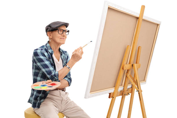 istock Senior artist looking at a painting 524713874
