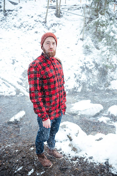 istock Man with beard standing at winter forest in snowy weather 524717672