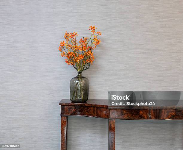 Sideboard In Front Of A Grey Wall With Flower Vase Stock Photo - Download Image Now - Flower, Autumn, Side Table