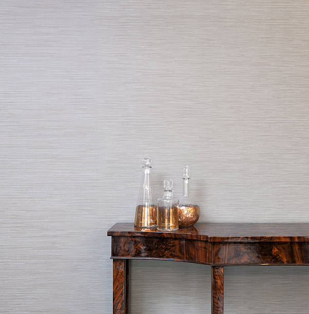 istock Sideboard in front of a grey wall with whiskey bottle 524718615