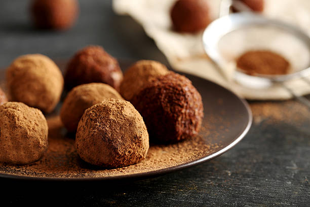istock Sweet chocolate truffle on a black wooden table 524718616
