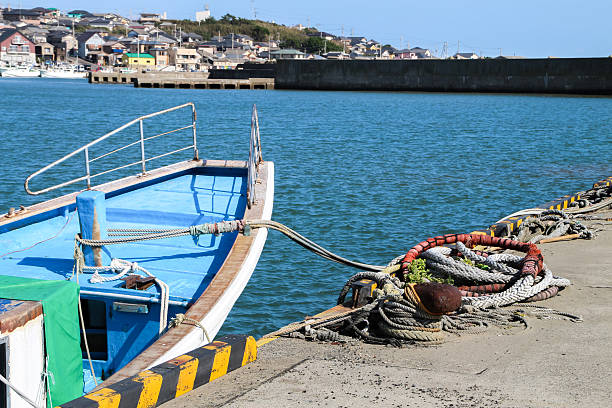 istock Old bollard with rope mooring and boats 524718706