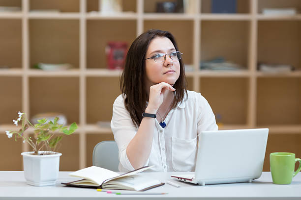 istock Young Woman thinking in relaxed Posture at working Place 524719086