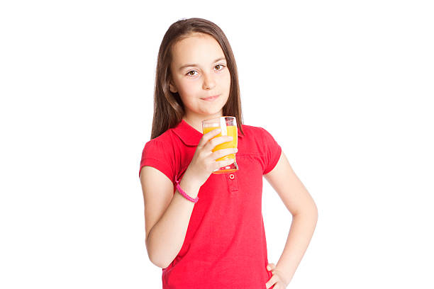 istock Cute girl drinking orange juice 524719124